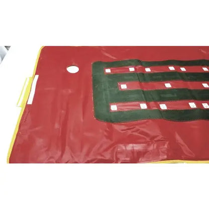 Red vinyl patient evacuation sled with green and white striped pattern for emergency patient evacuation mobility