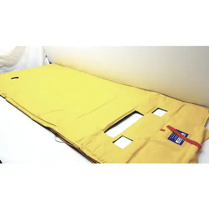 Yellow padded fire escape door cover with reinforced fabric and cutouts for evacusled emergency patient evacuation sled