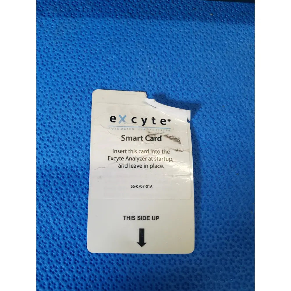 White excyte m automated smart card with black text and arrow for insertion into automated esr analyzer display