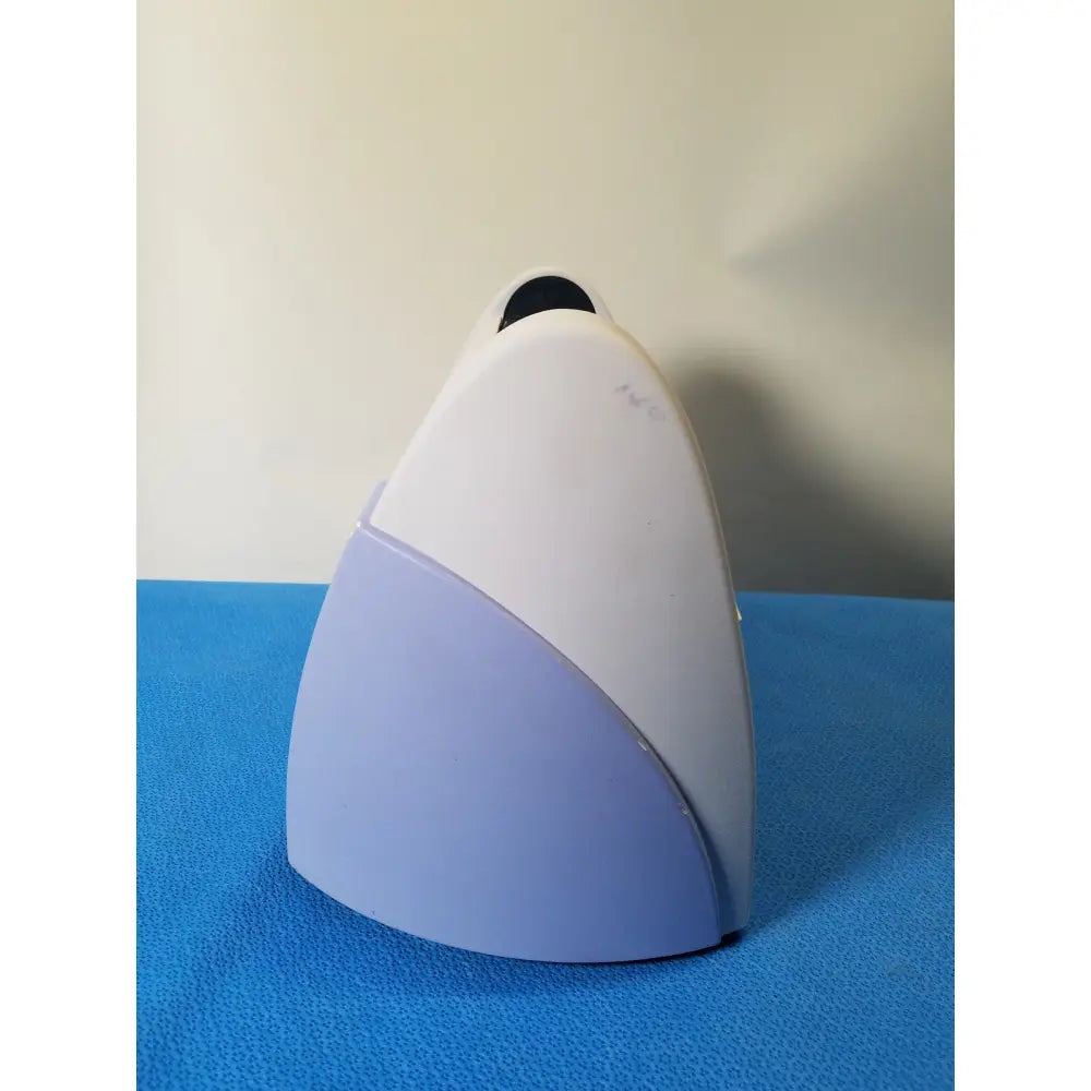 Excyte M automated esr analyzer is a sleek white and lavender plastic device with a rounded top and black lens