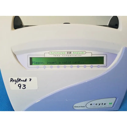 White and light blue plastic excyte m automated esr analyzer with green lcd screen displaying please insert a valid card message