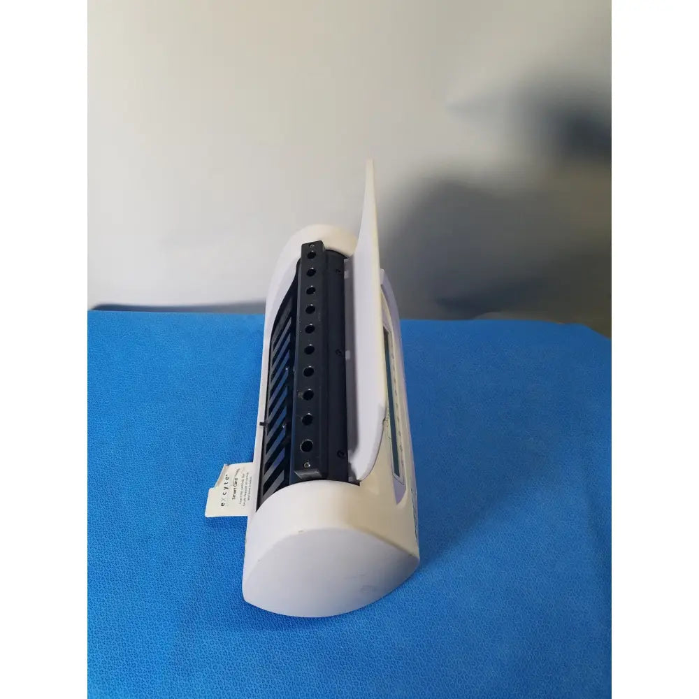 Excyte M automated white plastic baby scale with black vertical slot and digital display for automated ESR analysis