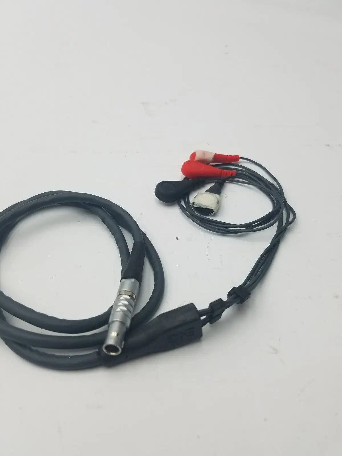 Black coiled lead set cable with metallic connector and red and white alligator clips for ekg ecg use