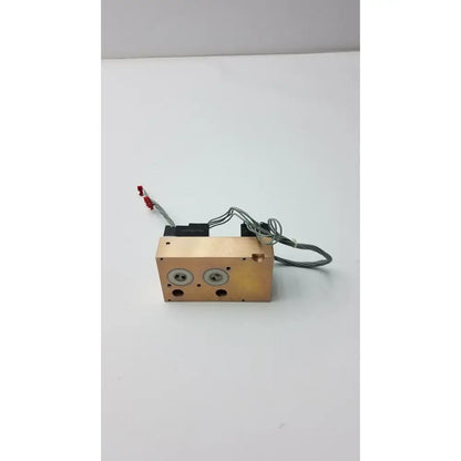 Copper-colored rectangular heat exchanger with two circular ports and gray wiring on fasmedic dräger evita xl mechanical ventilator back side