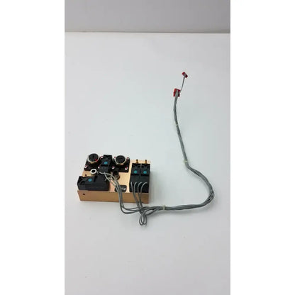 Beige rectangular electronic control panel with black knobs and switches connected by gray wires on fasmedic dräger evita xl mechanical ventilator