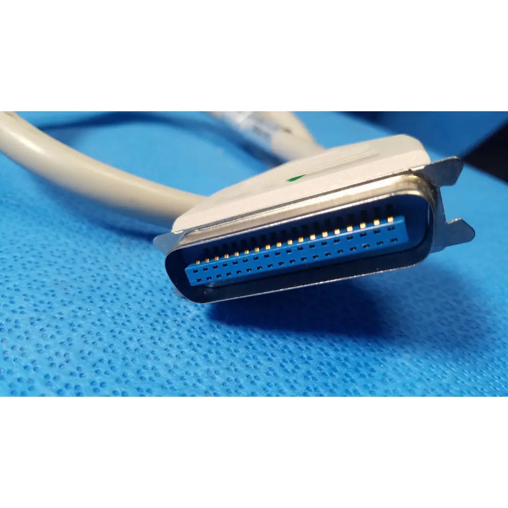 Female connector external scsi cable with white and blue db25 connector and metallic contacts attached to beige cable