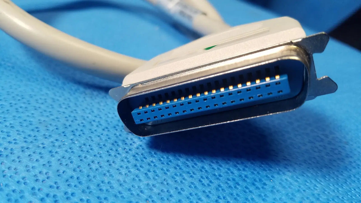 Female connector external scsi cable with white and blue db25 connector and metallic contacts attached to beige cable