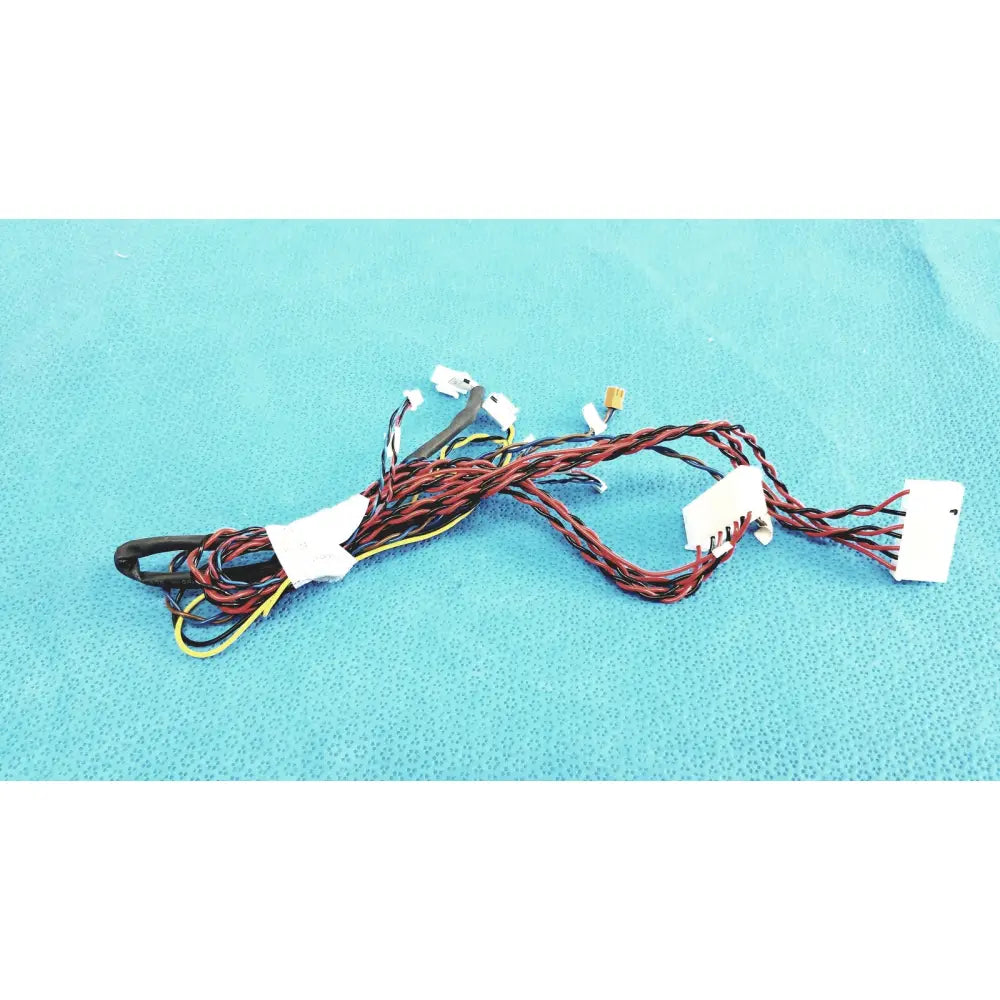 A tangle of red, black, and yellow female multi-pin connectors wire harness cables with white plastic connectors