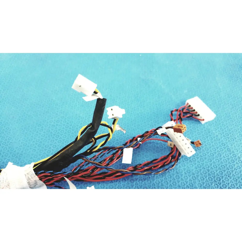 A bundle of female multi-pin connectors wire harness cables with black red and yellow wires ending in white plastic connectors