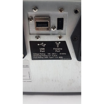Silver brushed metal back panel of filmarray instrument fa3112 pcr system with usb and firewire ports and specification label