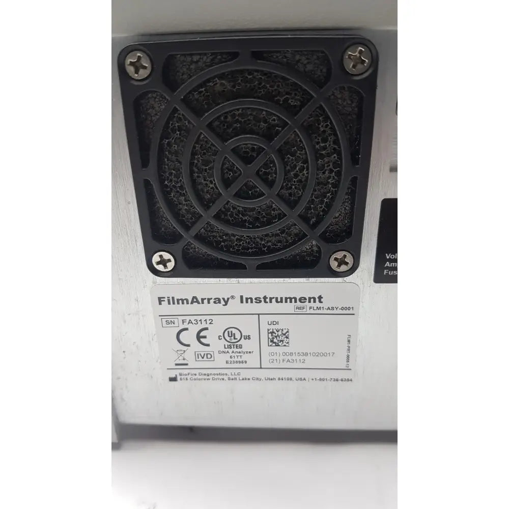 Black plastic ventilation grille with circular cross-hatched design and screws on back side of filmarray instrument fa3112 pcr system