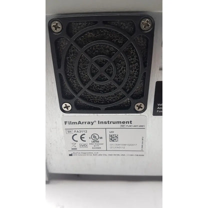 Black plastic ventilation grille with circular cross-hatched design and screws on back side of filmarray instrument fa3112 pcr system