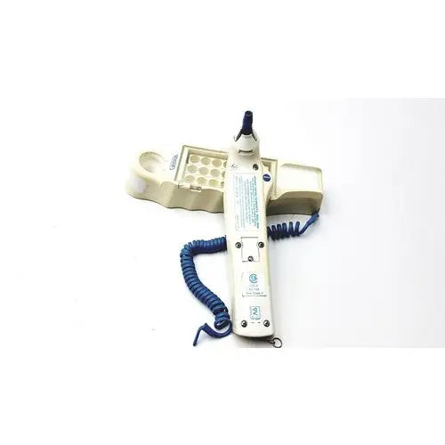 Beige medical device with blue coiled cord and matching tray with circular wells for firsttemp genius calibrator