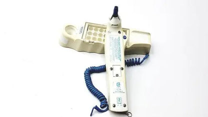 Beige medical device with blue coiled cord and matching tray with circular wells for firsttemp genius calibrator
