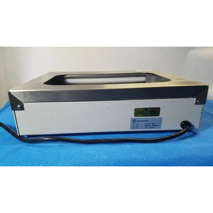 Silver and white Fisher Scientific tissueprep flotation bath ultrasonic cleaner with black power cord labeled vibra scientific