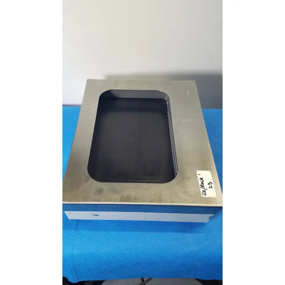 Silver metallic rectangular tissueprep flotation bath platform with black recessed center and white label by fisher scientific