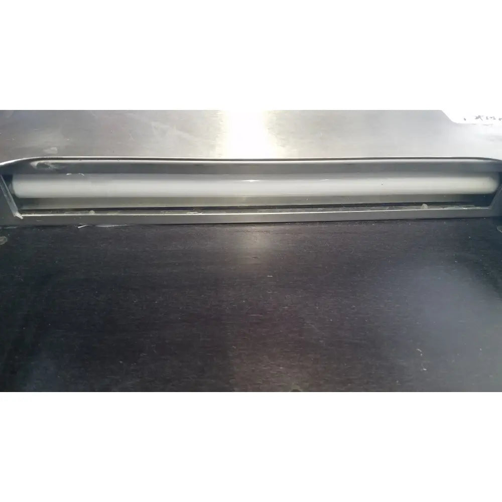 Silver metallic roller with smooth surface and rounded edges in fisher scientific tissueprep flotation bath metal frame
