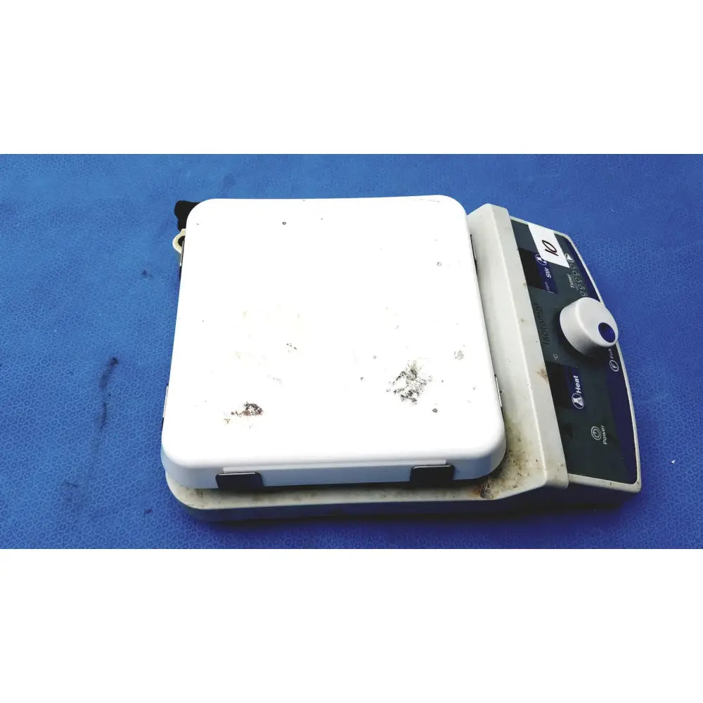 White rectangular fisher scientific isotemp digital hotplate stirrer with control panel and signs of use