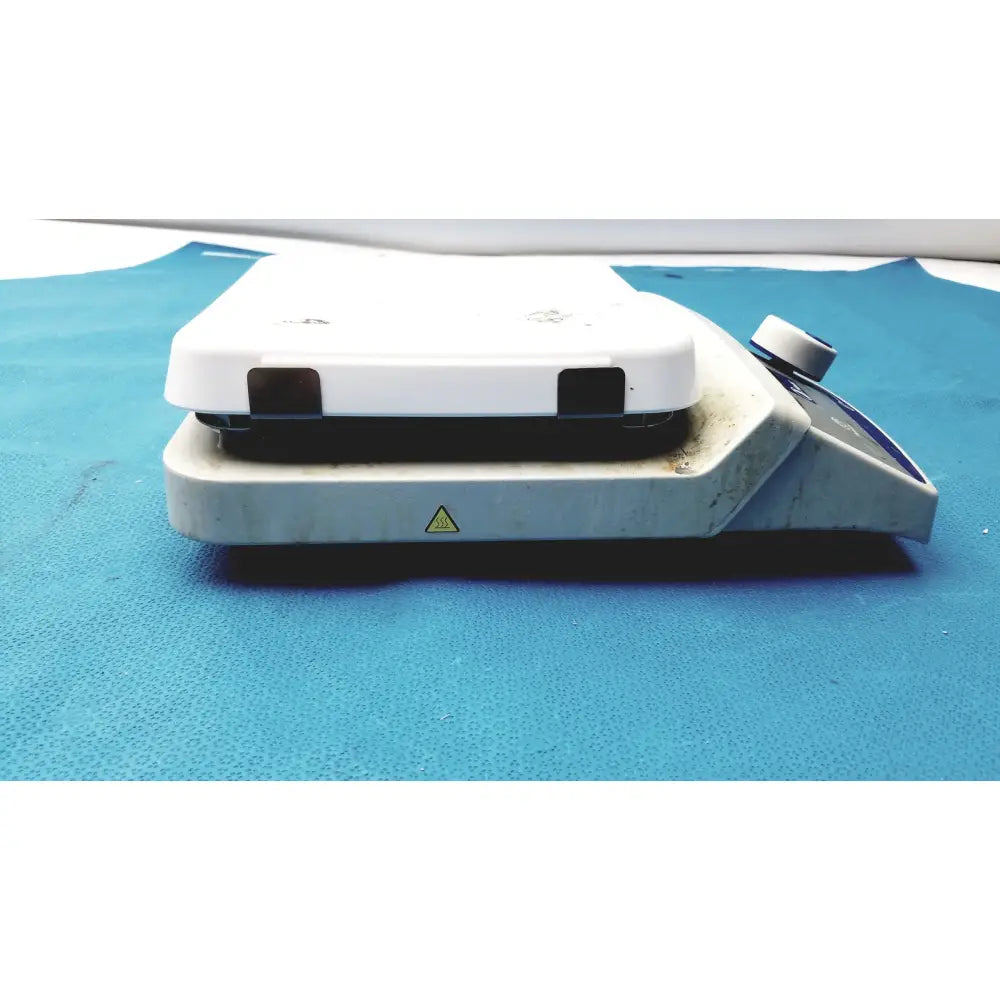 White laboratory hot plate with black heating surface and control knob in fisher scientific isotemp digital hotplate stirrer