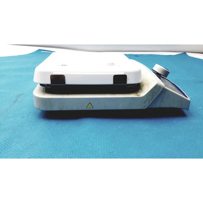 White laboratory hot plate with black heating surface and control knob in fisher scientific isotemp digital hotplate stirrer