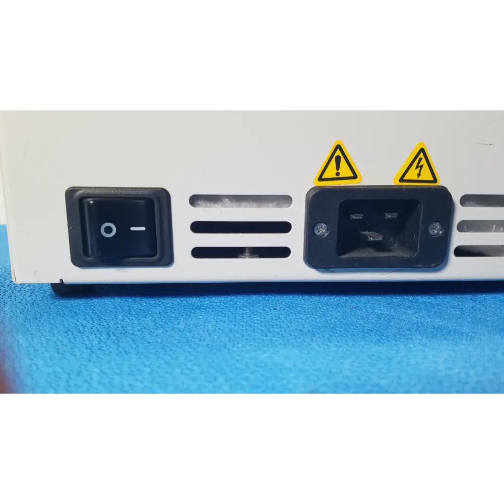 Back side of fisher scientific isotemp gpd 05 white water bath laboratory device with black power switch and high voltage labels