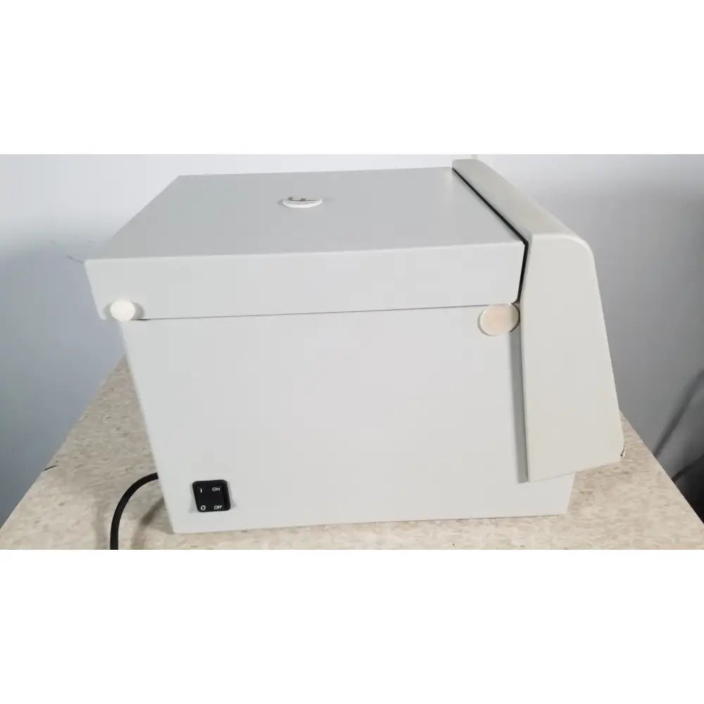 Gray plastic fisher scientific marathon 16km benchtop box with hinged lid white circular latches and on off switch