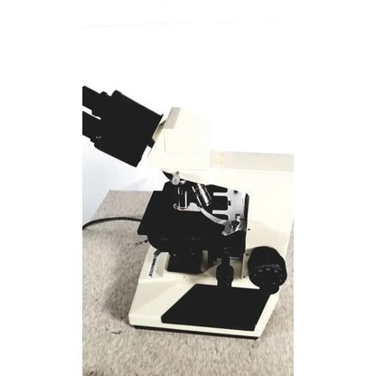 White and black compound microscope with adjustable focus knobs from fisher scientific micromaster cat 12-561-3faz