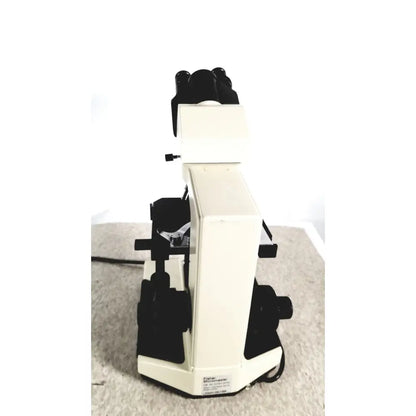 Cream-colored fisher scientific micromaster compound microscope with black eyepieces and stage clips scientific micromaster cat 12-561-3faz