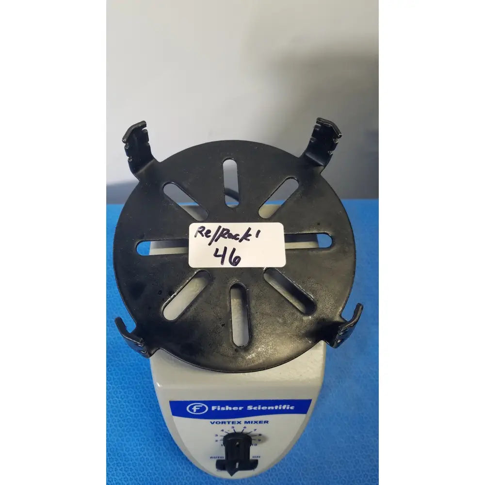 Black plastic circular rack with six slots and four side hooks on a white fisher scientific mini vortex mixer base