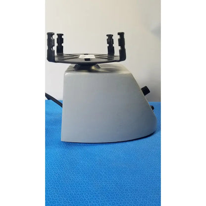 Gray plastic Fisher Scientific mini vortex mixer with black rotor and clamps for laboratory sample mixing use