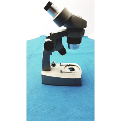 Black and silver Fisher Scientific Stereomaster II Microscope with adjustable eyepieces and stage clips for precision viewing
