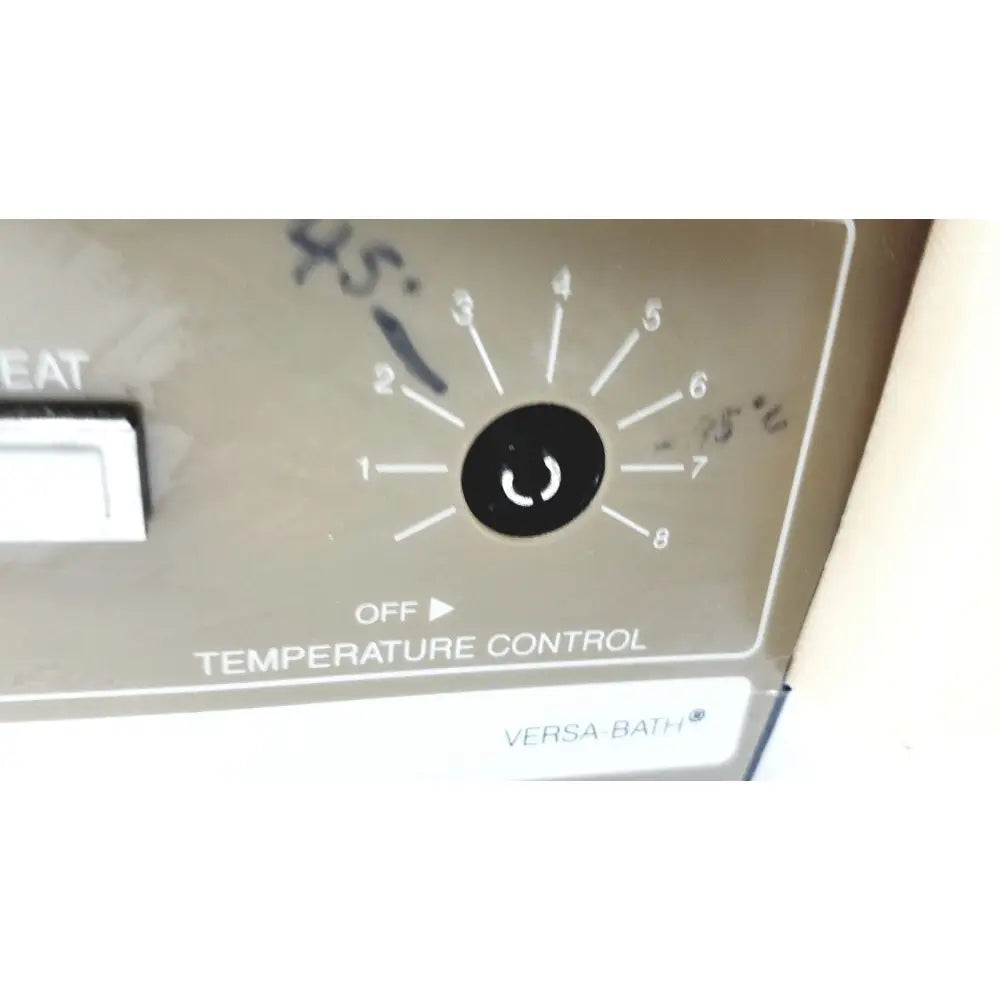 Gray plastic temperature control dial with numbered settings on fisher scientific versa-bath heated water bath model 139