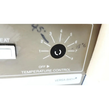 Gray plastic temperature control dial with numbered settings on fisher scientific versa-bath heated water bath model 139