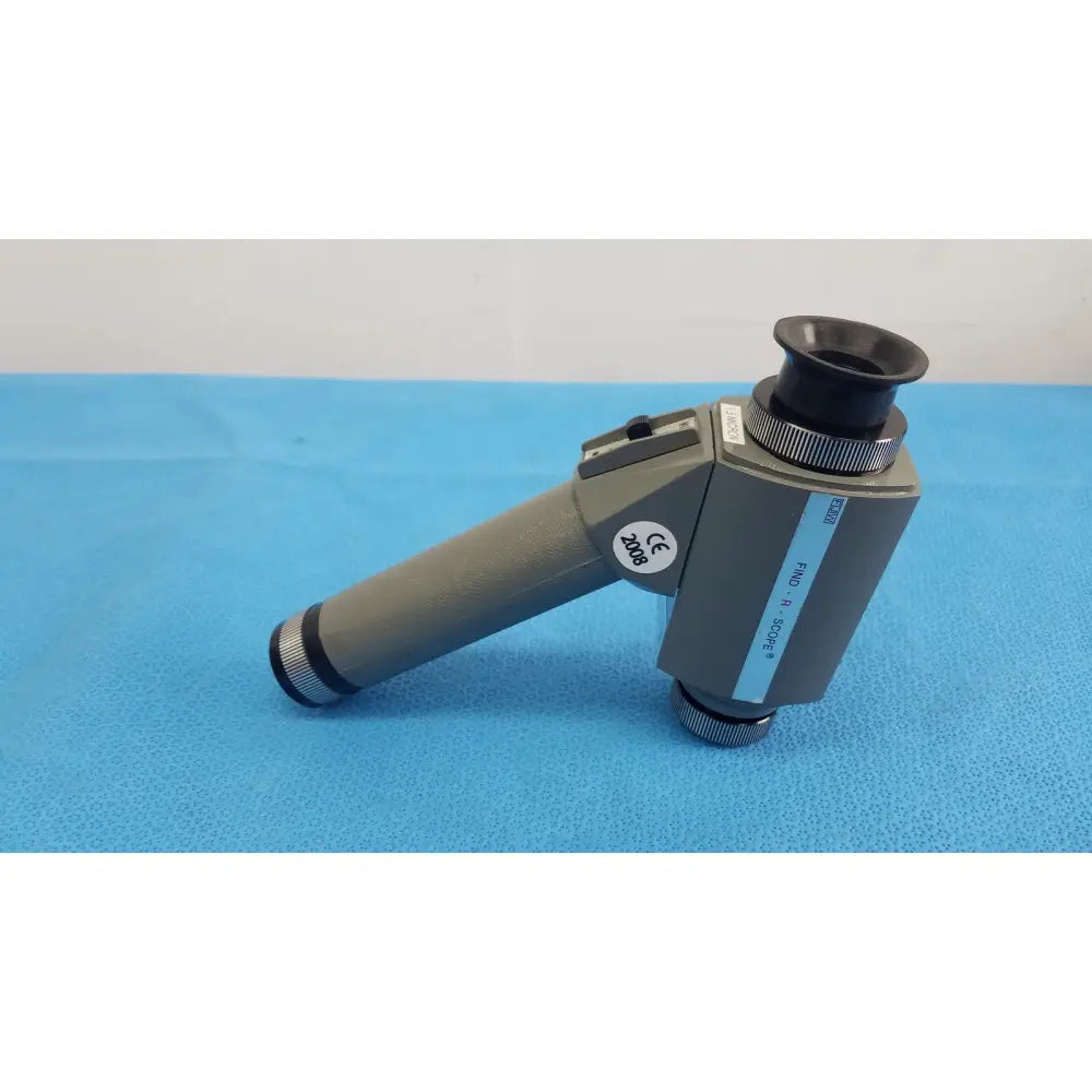 Gray handheld magnifier with black eyepiece and metallic accents featuring ce mark by fjw optical systems