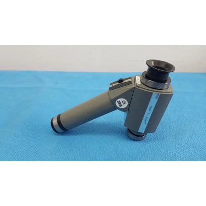 Gray handheld magnifier with black eyepiece and metallic accents featuring ce mark by fjw optical systems