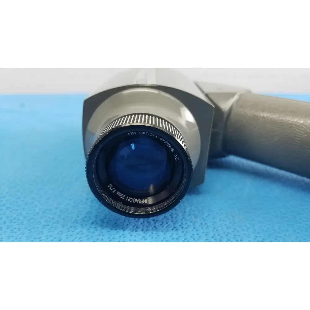 Gray and black medical-grade infrared camera lens with textured focus ring labeled infraroon 25mm f10 by FJW Optical Systems