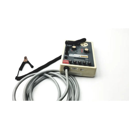 Beige rectangular fluke 180 electrical safety analyzer with black knobs switches and coiled gray cable for electrical safety