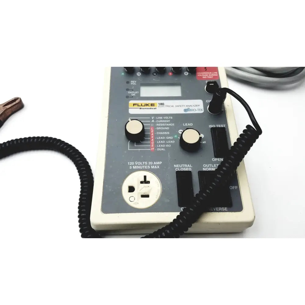 Fluke 180 electrical safety analyzer with beige casing black control knobs and coiled cable for electrical safety testing