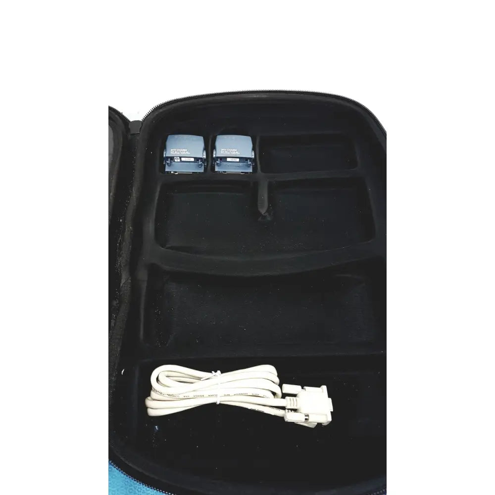 Black zippered carrying case with molded compartments holding two light blue Fluke DTX-1800 network cable certifier devices and coiled white cable