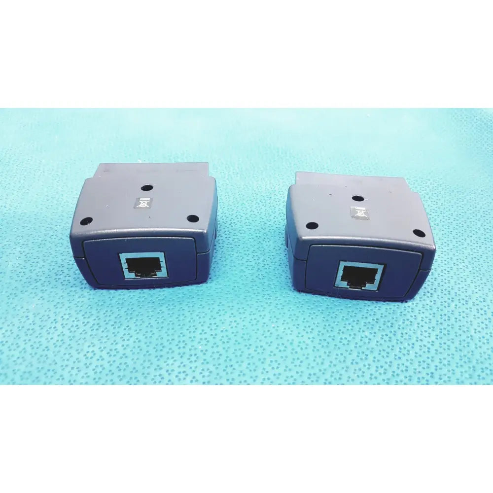 Two identical dark blue plastic ethernet extenders with gray panels for fluke dtx-1800 network cable certifier use