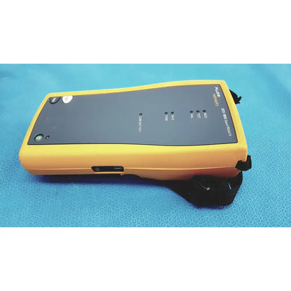 Yellow fluke dtx-380 smartmeter with black control panel and buttons used as a network cable certifier and cable analyzer