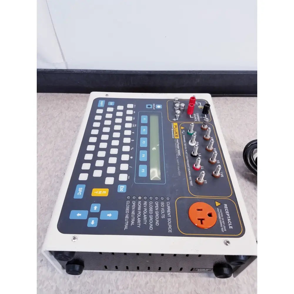 Fluke medtester 5000c automated electrical safety analyzer with gray black panel blue buttons and orange power receptacle