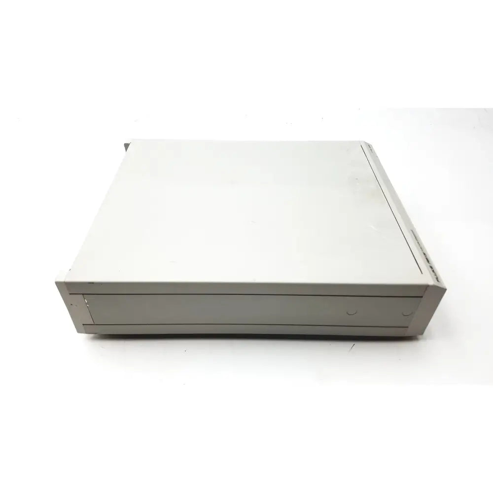 Beige plastic external hard drive with ventilation slots beside the fluke pm5139 function generator boxy design