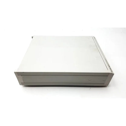 Beige plastic external hard drive with ventilation slots beside the fluke pm5139 function generator boxy design