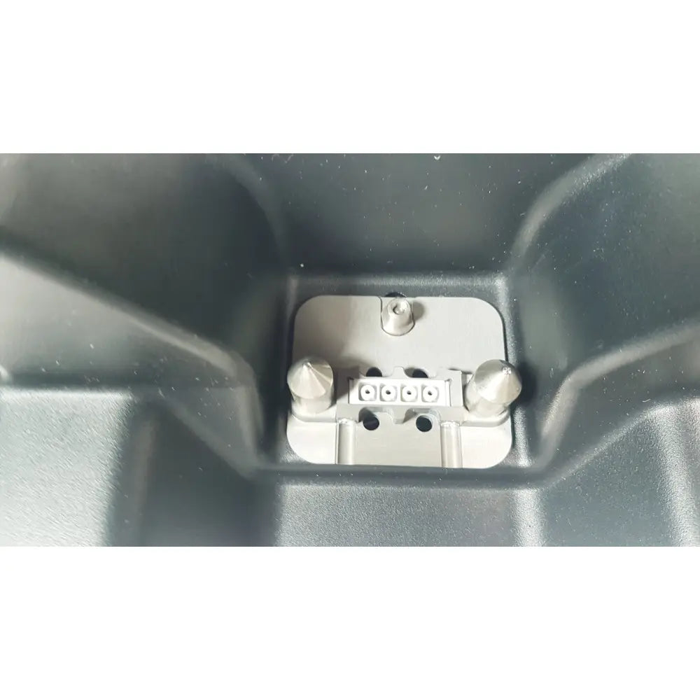 Silver metallic dental implant abutment with three holes and two conical posts for fuji film sonosite power pack dock