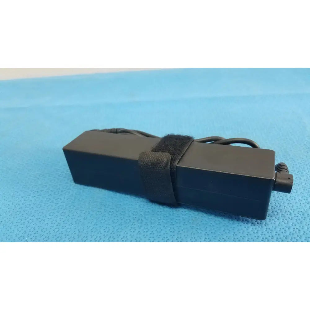 Black rectangular fujitsu ac adapter power supply 19v 3.16a with coiled power cord and black velcro strap