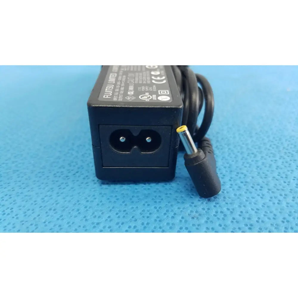 Black plastic fujitsu ac adapter power supply 19v 3.16a with coiled cord and yellow tip connector for laptop use