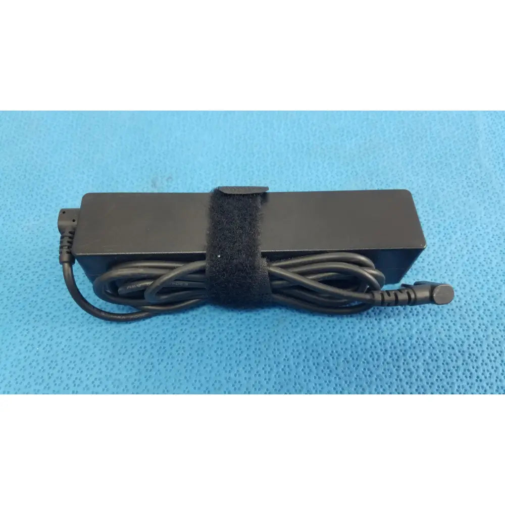 Black rectangular fujitsu ac adapter power supply 19v 3.16a with coiled cord and velcro strap for laptop charging