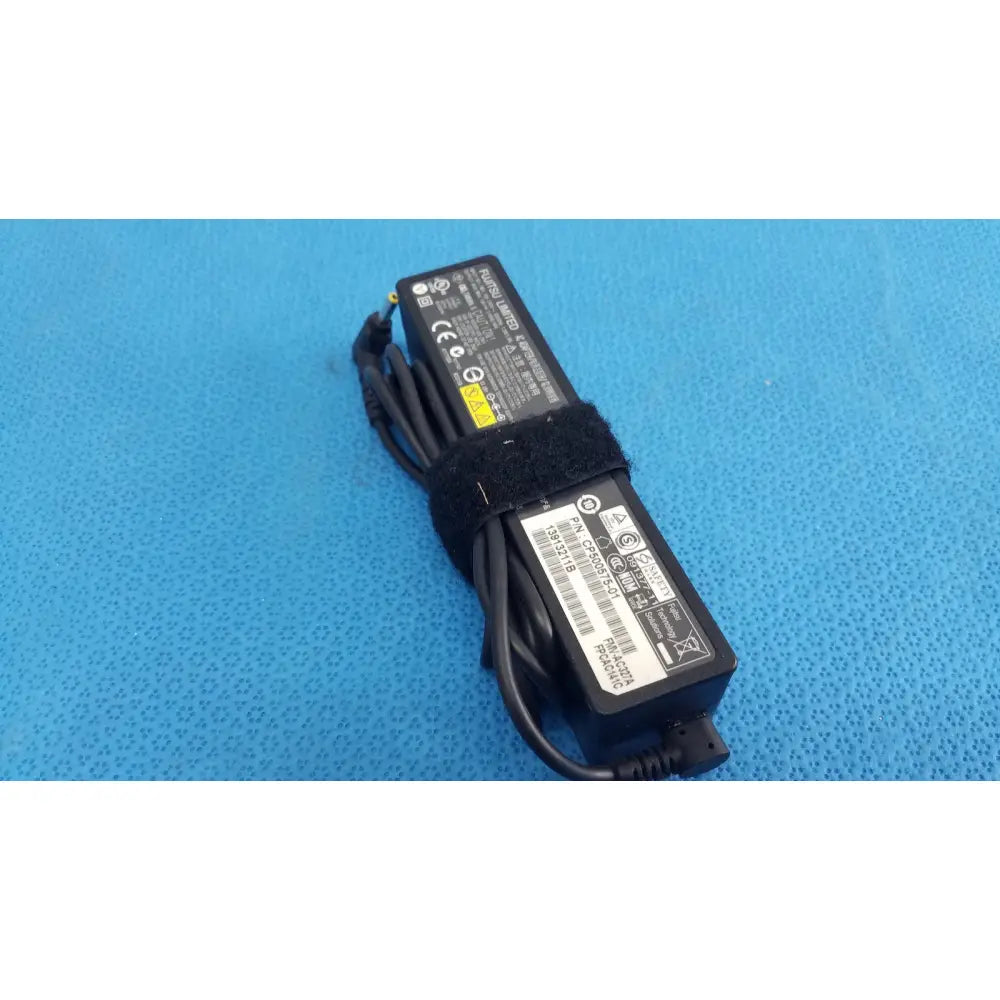 Black plastic fujitsu ac adapter power supply 19v 3.16a with coiled cable and velcro strap for laptop use