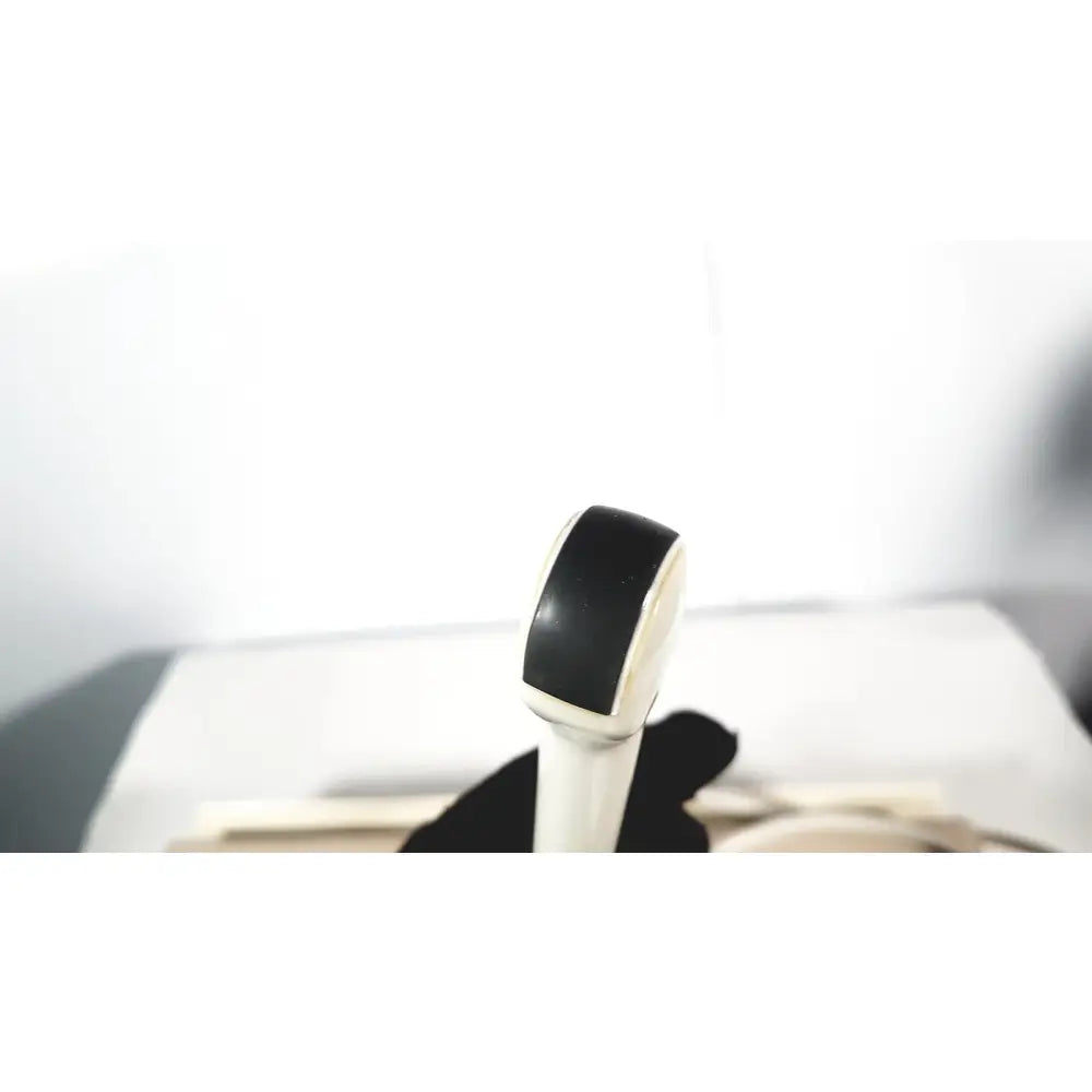 Black and white rubber eraser with smooth rounded top shown with fukuda denshi ultrasound probe trans vaginal model